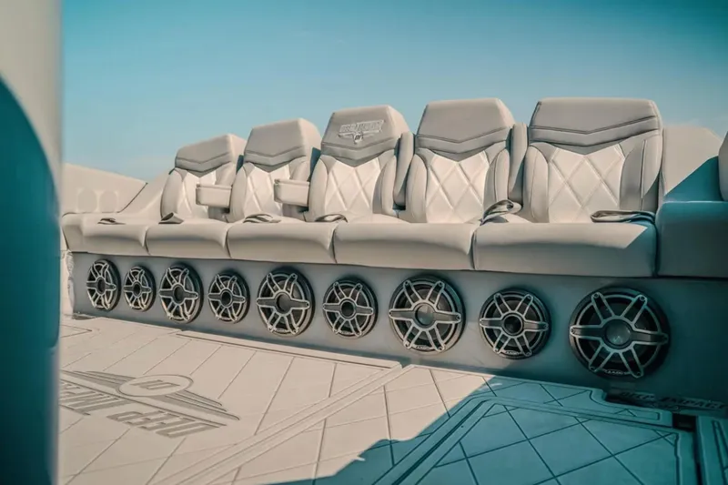Slide: The Image of Luxurious seating and speakers on 2026 Deep Impact 499 Sport boat interior. - 66