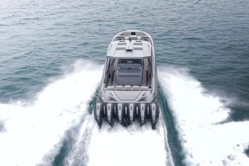 Slide: The Image of 2026 Deep Impact 499 Sport boat cruising on open water with powerful engines. - 8