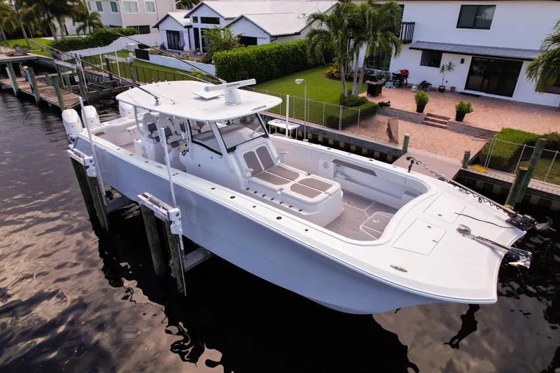 Slide: The Image of 2025 Front Runner 43 Catamaran docked by waterfront homes, showcasing sleek design and spacious deck. - 10
