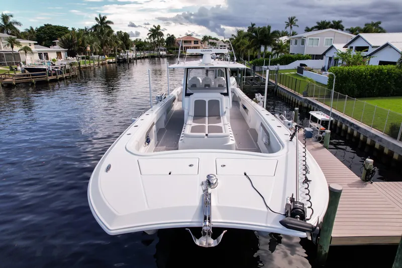 Slide: The Image of 2025 Front Runner 43 Catamaran docked in a scenic residential canal. - 11