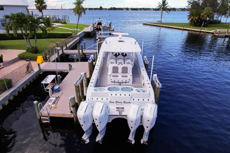 Slide: The Image of Front Runner 43 Catamaran 2025 docked by waterfront, featuring four powerful outboard engines. - 13