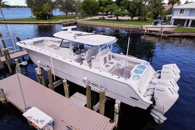 Slide: The Image of 2025 Front Runner 43 Catamaran docked, featuring sleek design and powerful Mercury engines. - 14