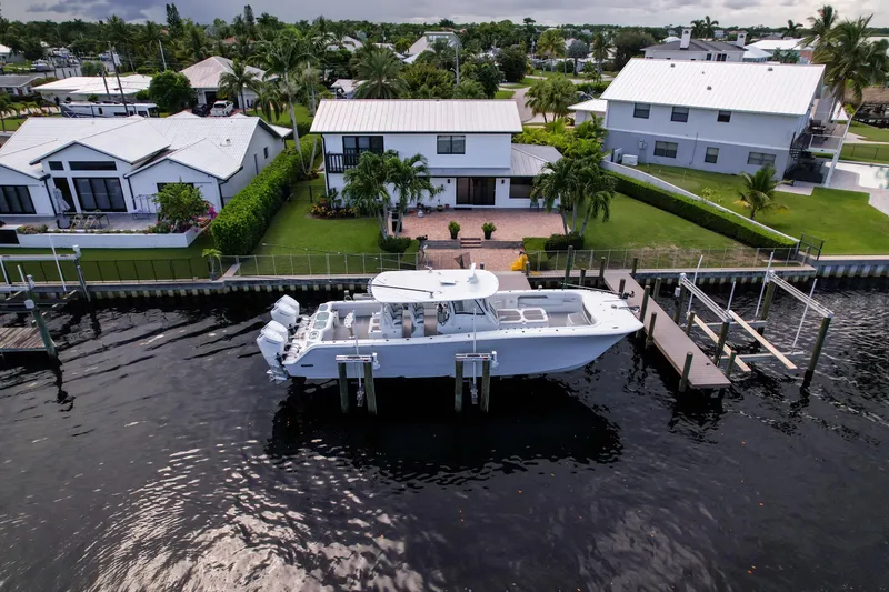 Slide: The Image of 2025 Front Runner 43 Catamaran docked by waterfront homes, showcasing luxury and modern design. - 17