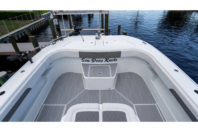 Slide: The Image of Front Runner 43 Catamaran 2025, featuring spacious deck and sleek design, docked by the water. - 21