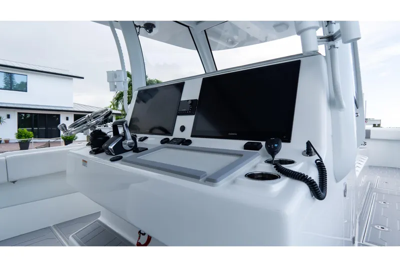 Slide: The Image of 2025 Front Runner 43 Catamaran helm with dual screens and modern controls. - 38