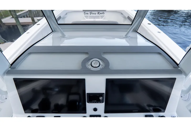 Slide: The Image of 2025 Front Runner 43 Catamaran helm with dual screens and compass. - 39