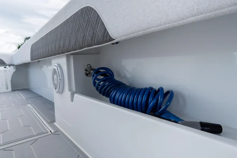 Slide: The Image of 2025 Front Runner 43 Catamaran deck with coiled blue hose and speaker. - 45