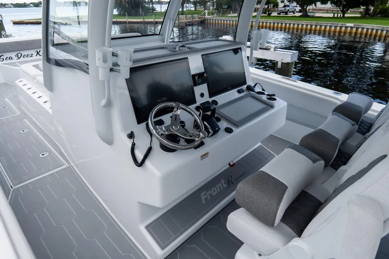 Slide: The Image of 2025 Front Runner 43 Catamaran cockpit with modern controls and seating, dockside view. - 46