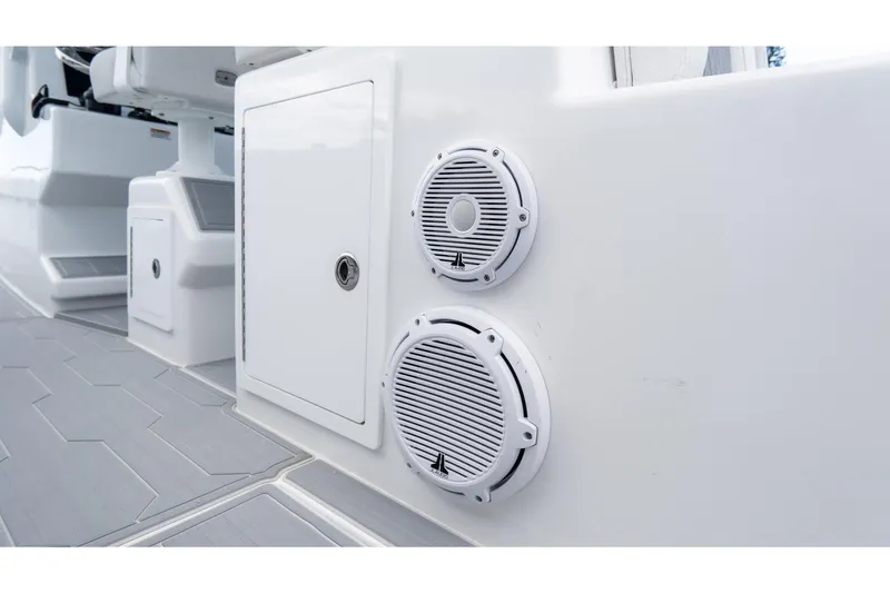 Slide: The Image of 2025 Front Runner 43 Catamaran interior with white speakers and storage compartments. - 53