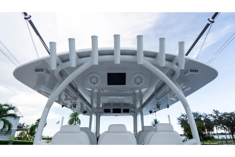Slide: The Image of 2025 Front Runner 43 Catamaran helm with rod holders and electronics, set against a tropical backdrop. - 58