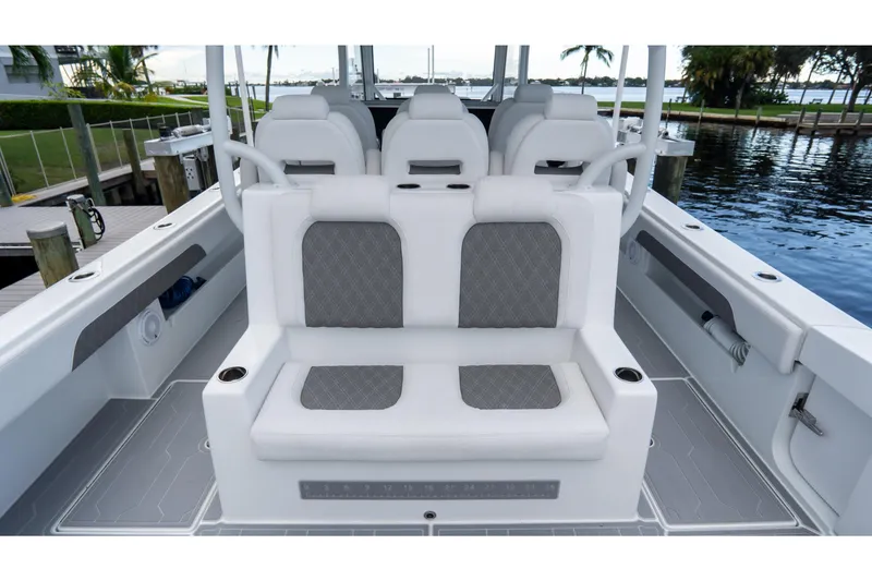 Slide: The Image of 2025 Front Runner 43 Catamaran interior with cushioned seating and cup holders by the water. - 59