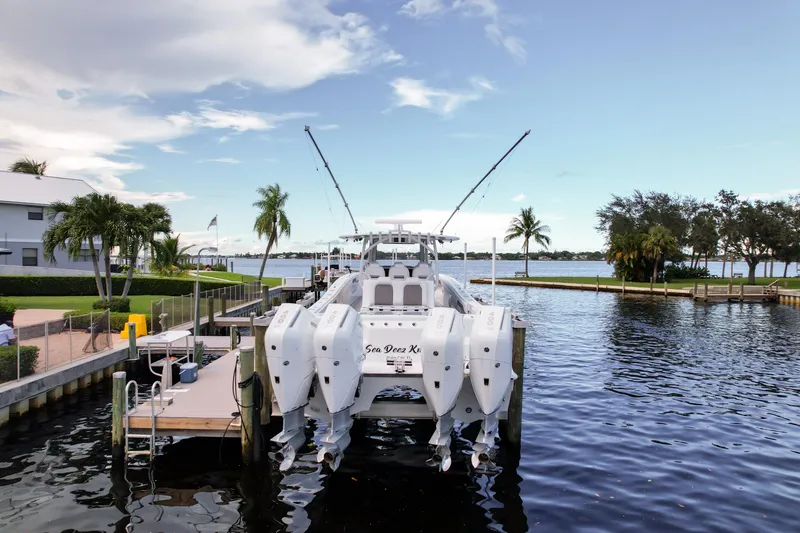 Slide: The Image of 2025 Front Runner 43 Catamaran docked by a scenic waterfront with palm trees. - 6