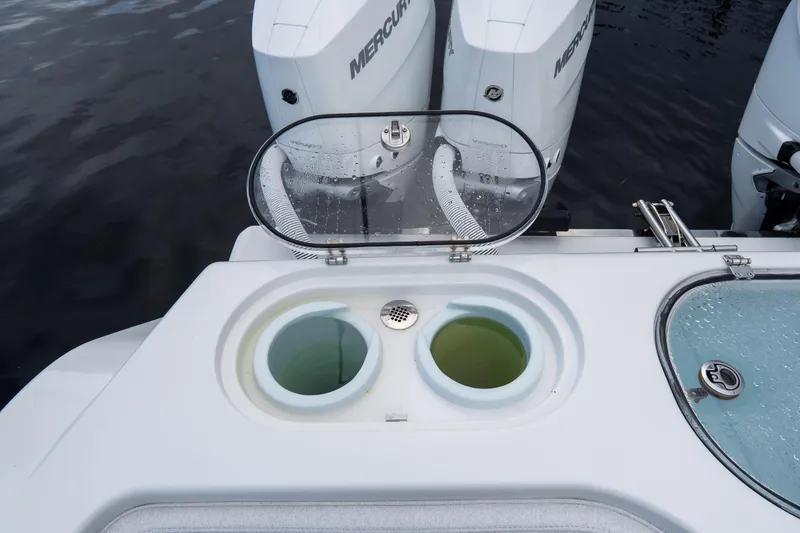 Slide: The Image of Livewell and engines on 2025 Front Runner 43 Catamaran, featuring dual Mercury outboards. - 66