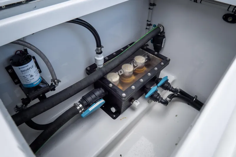 Slide: The Image of Engine compartment of 2025 Front Runner 43 Catamaran with visible plumbing and filtration system. - 75