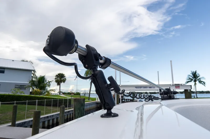 Slide: The Image of 2025 Front Runner 43 Catamaran with mounted equipment, docked near palm trees. - 77