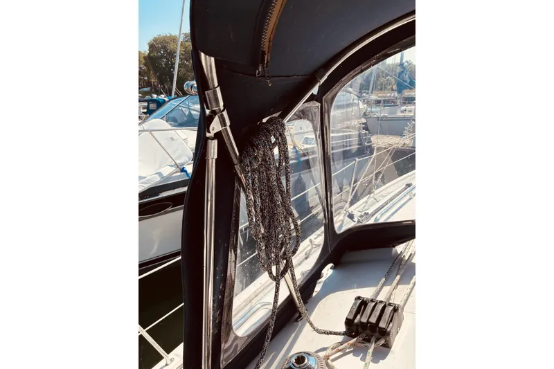 Slide: The Image of 2005 Hunter 33 sailboat cockpit with ropes and canopy in marina. - 11