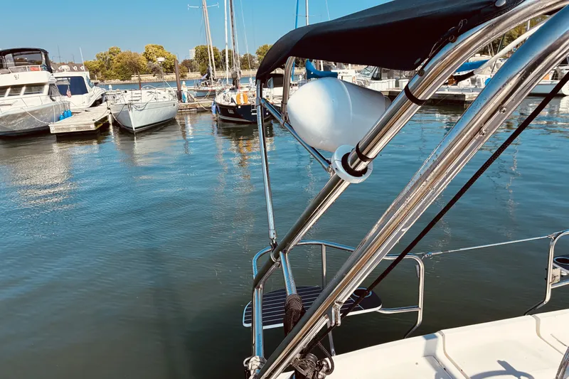 Slide: The Image of Hunter 33 sailboat docked at marina, 2005 model, with clear blue water and boats. - 12