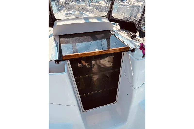 Slide: The Image of 2005 Hunter 33 sailboat cockpit entrance with wooden trim and clear panels. - 15