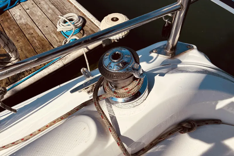 Slide: The Image of Winch and ropes on a 2005 Hunter 33 sailboat deck near a dock. - 18
