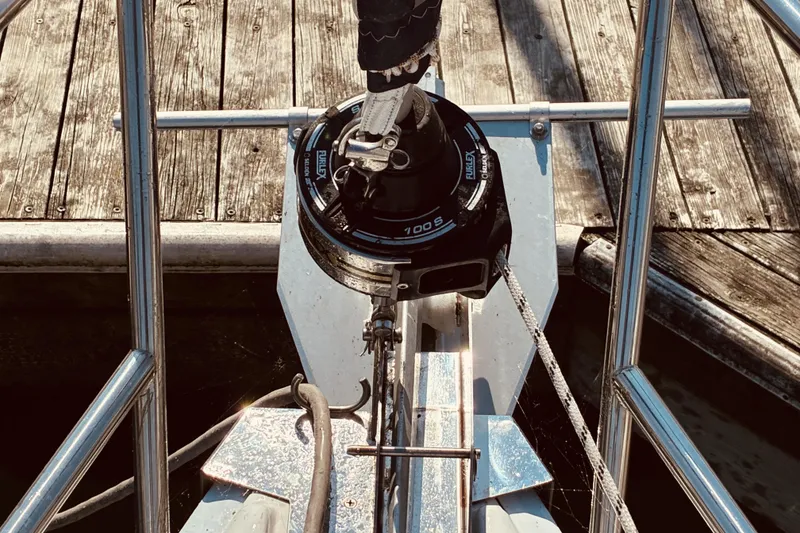 Slide: The Image of Bow of 2005 Hunter 33 sailboat with furler and dock background. - 23