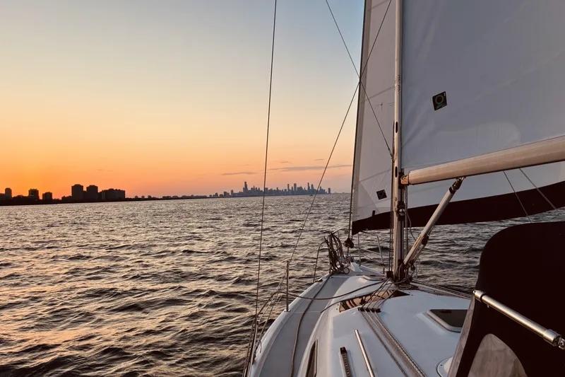 Slide: The Image of Sailboat on water at sunset with city skyline in distance, Hunter 33, 2005 model. - 26