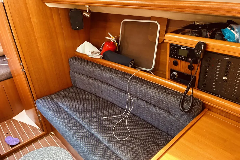 Slide: The Image of Interior of 2005 Hunter 33 sailboat with seating, radio, and fire extinguisher. - 27
