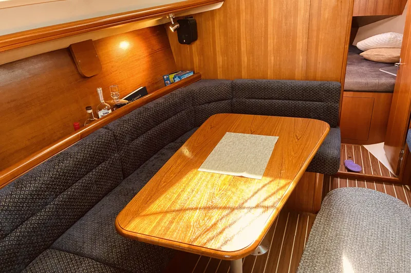 Slide: The Image of Cozy interior of a 2005 Hunter 33 sailboat with wooden dining area. - 28