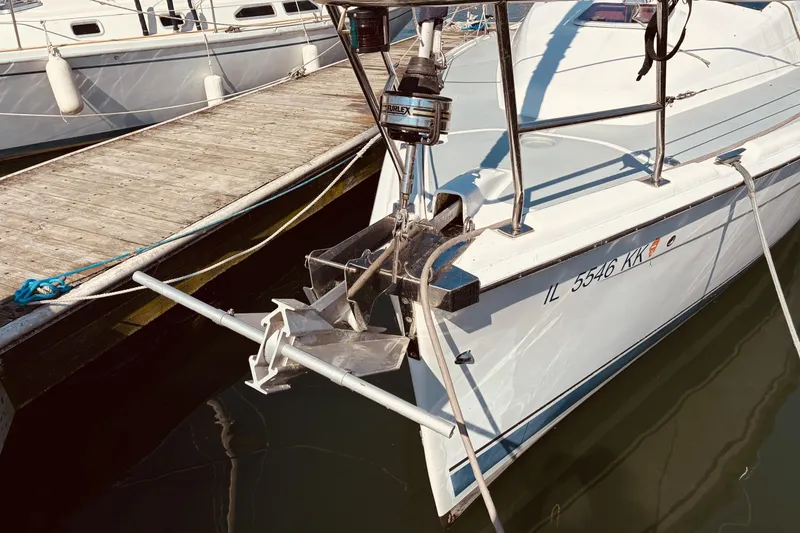 Slide: The Image of 2005 Hunter 33 sailboat docked, featuring anchor and registration number IL 5546 KK. - 3