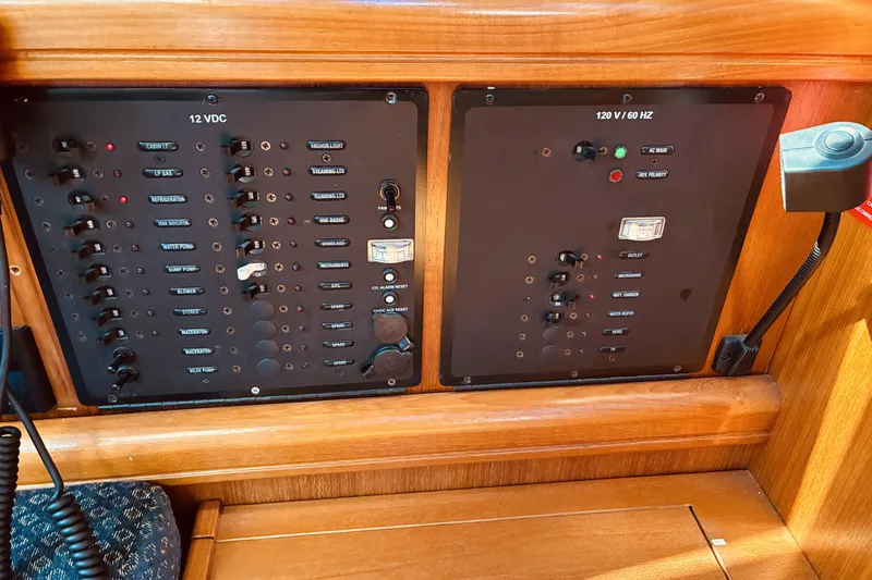 Slide: The Image of Electrical control panel on a 2005 Hunter 33 sailboat, featuring 12V and 120V systems. - 33