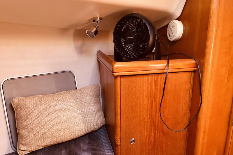 Slide: The Image of Cozy cabin interior of 2005 Hunter 33 sailboat with fan and cushion. - 37