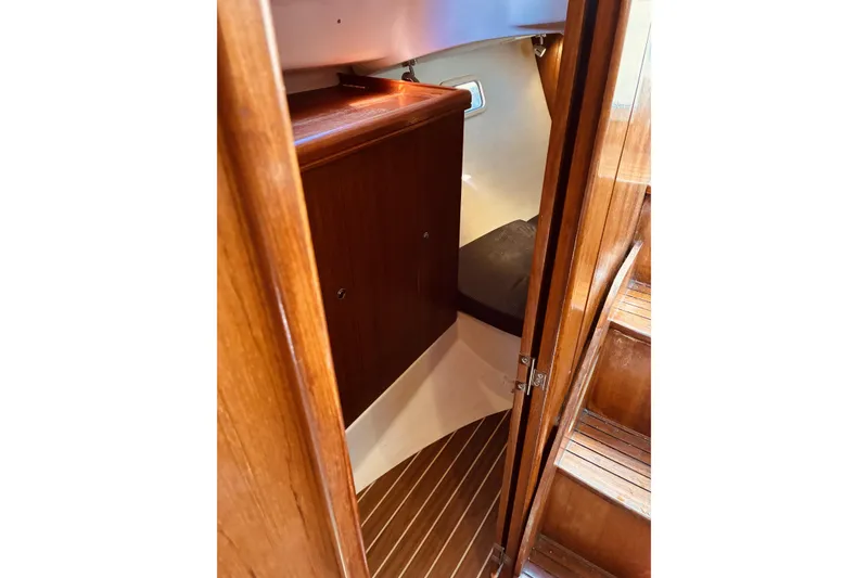 Slide: The Image of Interior of 2005 Hunter 33 sailboat with wooden cabinetry and steps. - 39