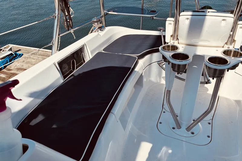 Slide: The Image of Cockpit of 2005 Hunter 33 sailboat with seating and cup holders. - 6