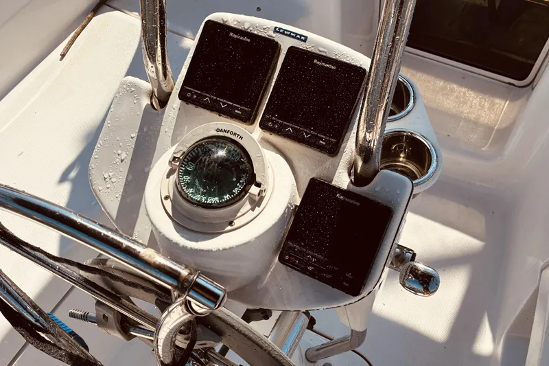 Slide: The Image of Steering console of a 2005 Hunter 33 sailboat with compass and instruments. - 9