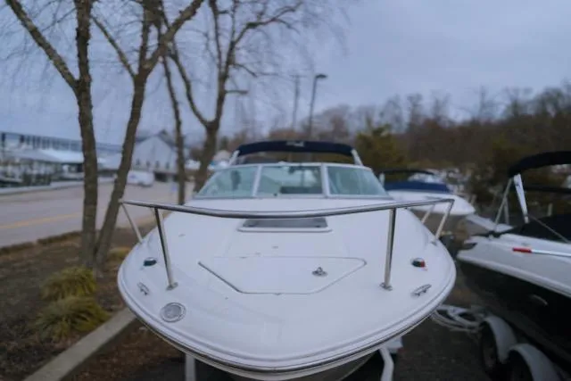 Slide: The Image of 2007 Sea Ray 215 Weekender boat on trailer, parked outdoors. - 4