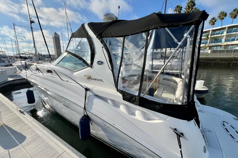 Slide: The Image of 2004 Sea Ray 320 Sundancer docked at marina under clear blue sky. - 10