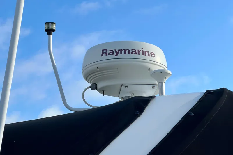 Slide: The Image of Raymarine radar on 2004 Sea Ray 320 Sundancer against blue sky. - 12