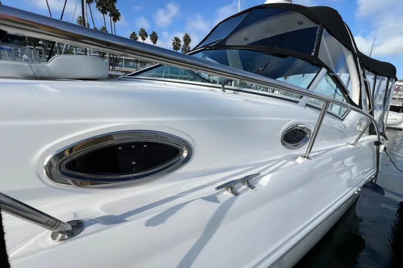 Slide: The Image of 2004 Sea Ray 320 Sundancer boat with sleek design and stainless steel railings. - 13