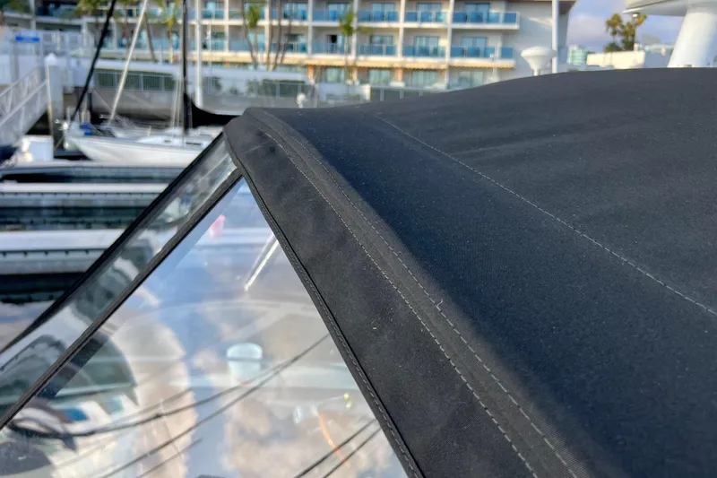 Slide: The Image of Close-up of 2004 Sea Ray 320 Sundancer's black canvas top at marina. - 16
