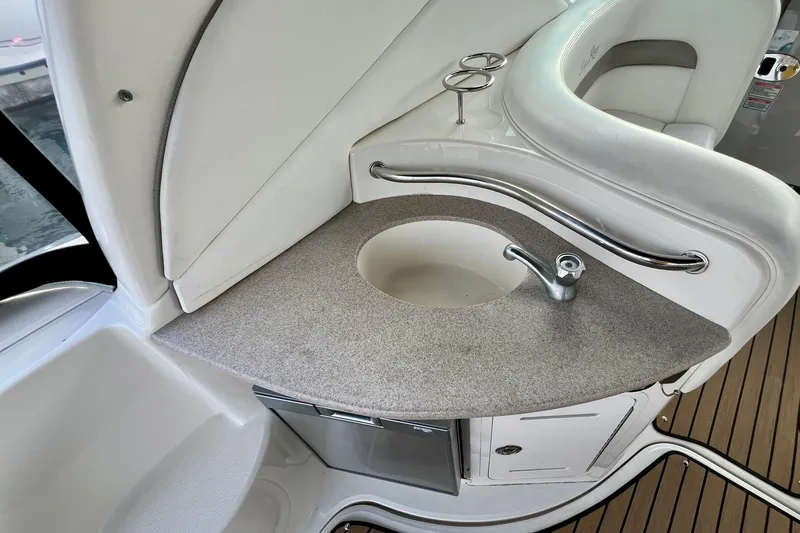 Slide: The Image of 2004 Sea Ray 320 Sundancer boat interior with sink and seating area. - 28