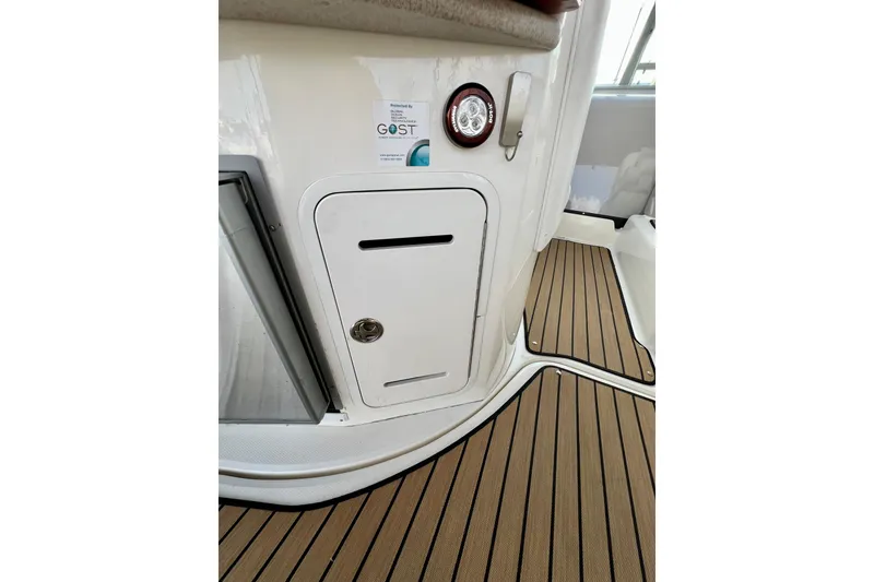 Slide: The Image of 2004 Sea Ray 320 Sundancer interior with wooden flooring and storage compartment. - 30