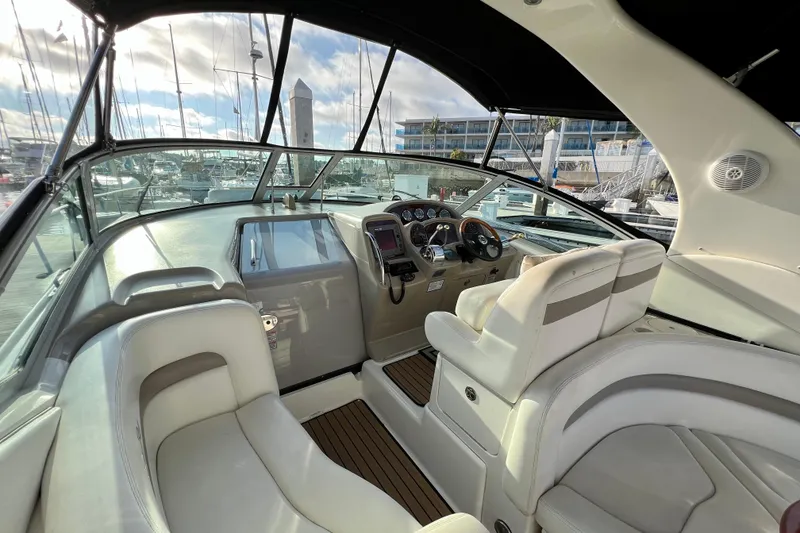 Slide: The Image of 2004 Sea Ray 320 Sundancer cockpit with modern controls and comfortable seating. - 34