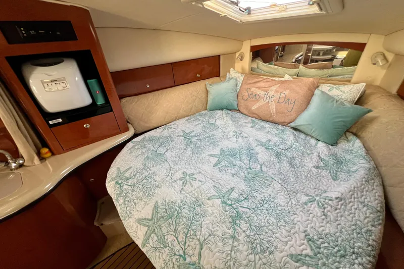 Slide: The Image of Cozy cabin interior of 2004 Sea Ray 320 Sundancer with nautical-themed bedding. - 53