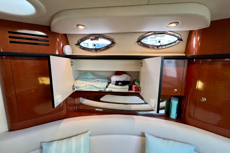 Slide: The Image of Interior cabin storage of 2004 Sea Ray 320 Sundancer yacht with open cabinets. - 56