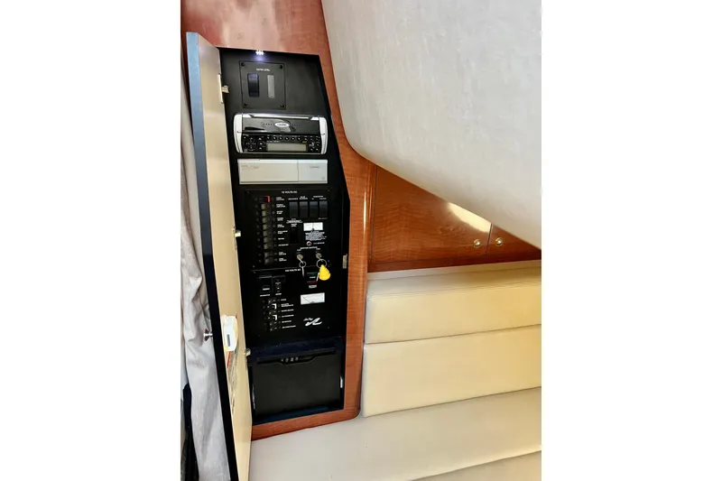 Slide: The Image of Control panel inside 2004 Sea Ray 320 Sundancer yacht, featuring various switches and controls. - 59