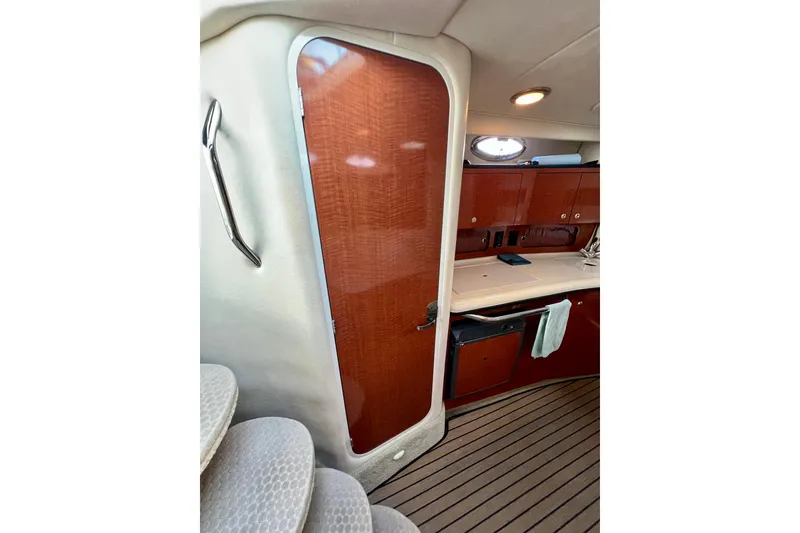 Slide: The Image of Interior of 2004 Sea Ray 320 Sundancer with wooden cabinetry and carpeted stairs. - 61