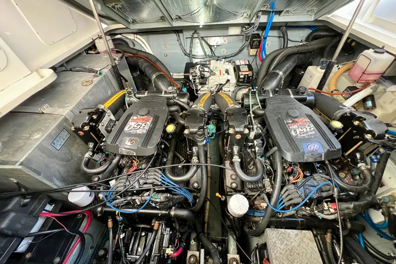 Slide: The Image of Engine compartment of a 2004 Sea Ray 320 Sundancer boat, showcasing dual engines. - 64