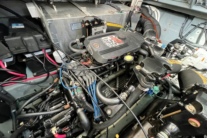 Slide: The Image of Engine compartment of a 2004 Sea Ray 320 Sundancer boat, showcasing detailed components. - 65