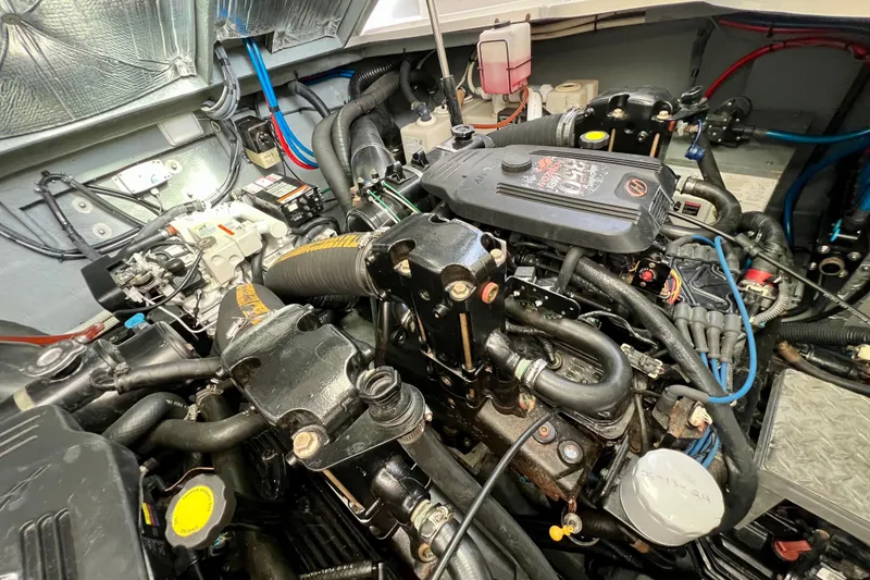 Slide: The Image of Engine compartment of a 2004 Sea Ray 320 Sundancer boat, showcasing detailed components. - 66