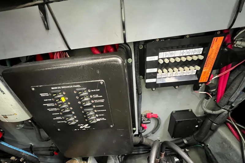 Slide: The Image of Electrical panel of a 2004 Sea Ray 320 Sundancer boat, showing circuit breakers and wiring. - 70