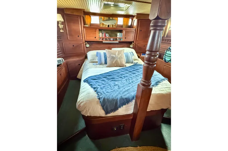 Slide: The Image of Cozy 1980 Nauticat Pilothouse bedroom with wooden interior and comfortable bedding. - 13
